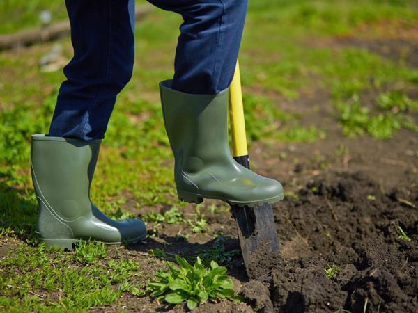 Man digging garden with shovel